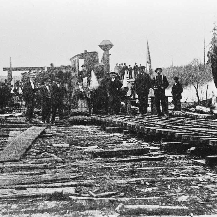 "Ant" and visitors during the opening day excursion, along the shore of Lake Union in March 1872.