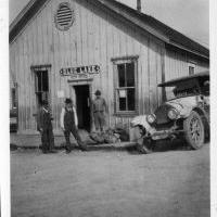 Three men and a stage auto in front of Blue Lake Depot / Post Office.