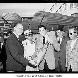 Elvis Presley presenting gift to Washington Governor Rosellini, Monorail Station, Westlake Avenue, Seattle, September 5, 1962